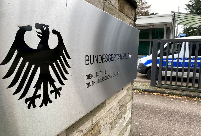 A police vehicle drives past a sign at the entrance of the German Federal Supreme Court Bundesgerichtshof in Karlsruhe