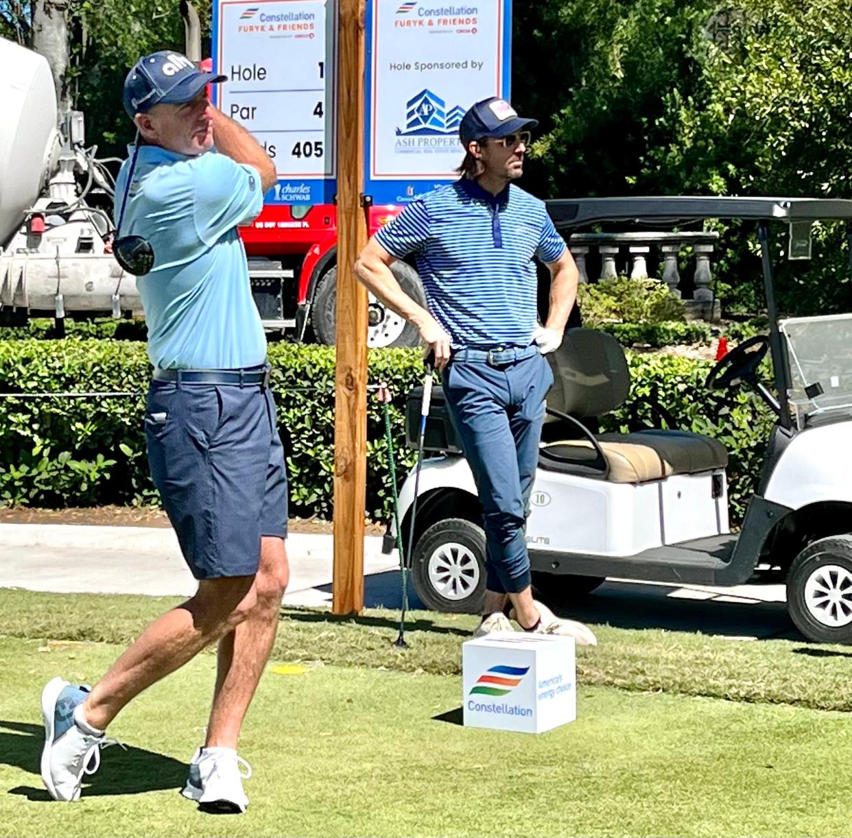 Country star Jake Owen (right) watches tournament host Jim Furyk tee off on Tuesday at the Timuquana Country Club during a practice round for the Constellation Furyk & Friends PGA Tour Champions event. Owen will perform in a concert at Daily's Place later Tuesday.