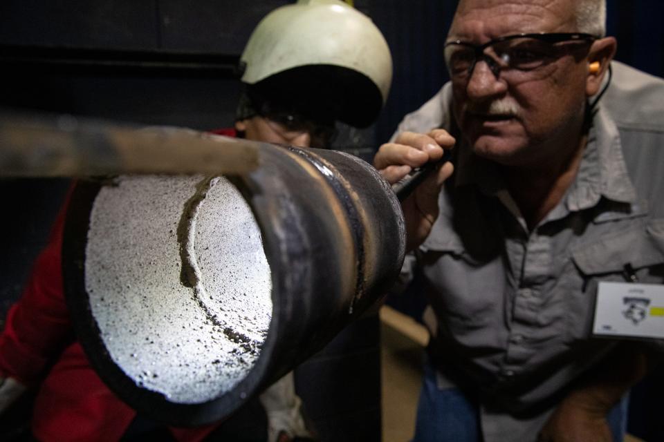 Competition judge Steve Woolery, of Ohmstede, checks a weld by duel credit Robstown student Evan Ybarra during a competition at Del Mar College on Friday, Nov. 3, 2023.