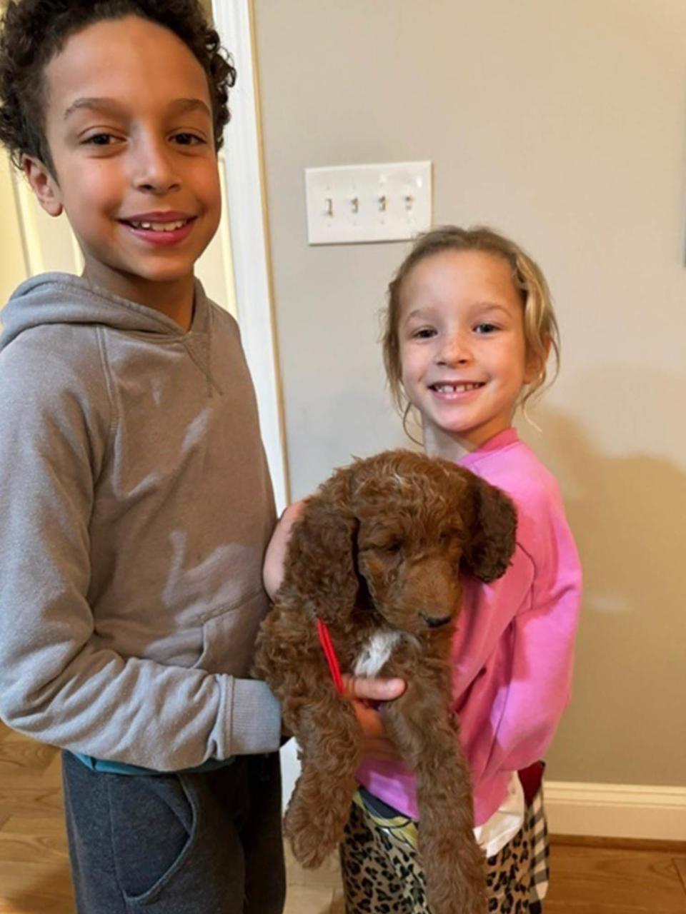 Craig Melvin's kids hold their new puppy named Myles. (Courtesy Craig Melvin)