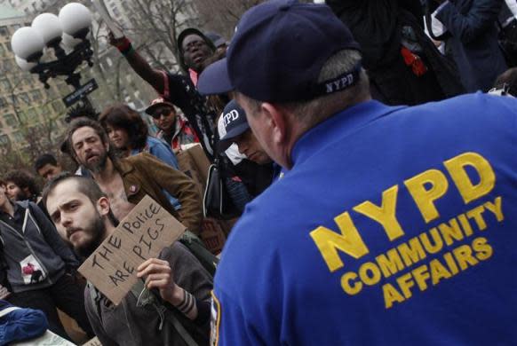 Occupy Wall Street protestors react as they are told to remove banners and signs from an area of Union Square Park in New York City by police March 21, 2012.