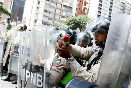 Security forces block a street using riot shields and pepper spray during an opposition rally in Caracas, Venezuela April 4, 2017. REUTERS/Carlos Garcia Rawlins