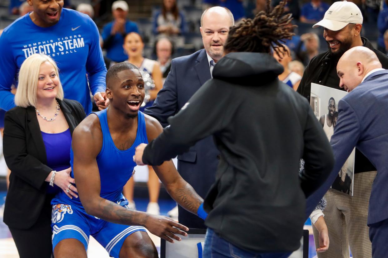 Memphis' David Jones (8) is surprised by his sister Flor Elena Jones as he is honored during a senior day celebration before the game between University of Alabama at Birmingham and University of Memphis at FedExForum in Memphis, Tenn., on Sunday, March 3, 2024.