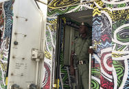 A police officer stand guards inside a train at the train station in Abuja, Nigeria, Monday, Dec. 5, 2022. Train service in Nigeria's capital city resumed on Monday, eight months after assailants attacked a train with explosives and gunfire, killing seven people and abducting dozens of passengers. (AP Photo/Chinedu Asadu)