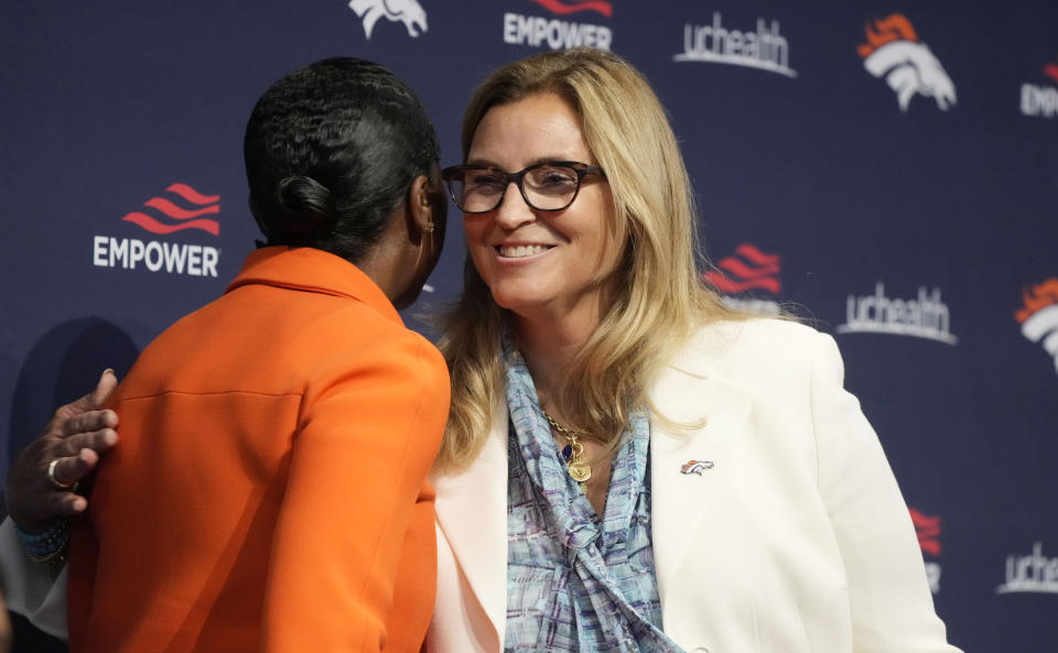 Carrie Walton Penner, right, greets Mellody Hobson during a news conference at Denver Broncos headquarters Wednesday, Aug. 10, 2022, in Centennial, Colo. Hobson is a limited partner in the Walton Penner ownership group that purchased the NFL football team. (AP Photo/David Zalubowski)