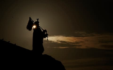 Pipe Major Trevor Macey-Lillie of the Scots Royal artillery performs at Mulberry harbour  - Credit: Getty