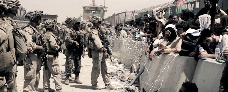 Pictured: Soldiers â€“ barbed wire - crowd - Evacuation. (Channel 4)