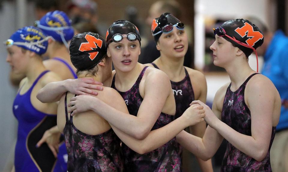 The Marlington girls 400 yard freestyle relay team hugs each other after placing third in the event with a time of 3:34.15 during the Division II State Swimming Championship at CT Branin Natatorium, Friday, Feb. 25, 2022, in Canton, Ohio. [Jeff Lange/Beacon Journal]