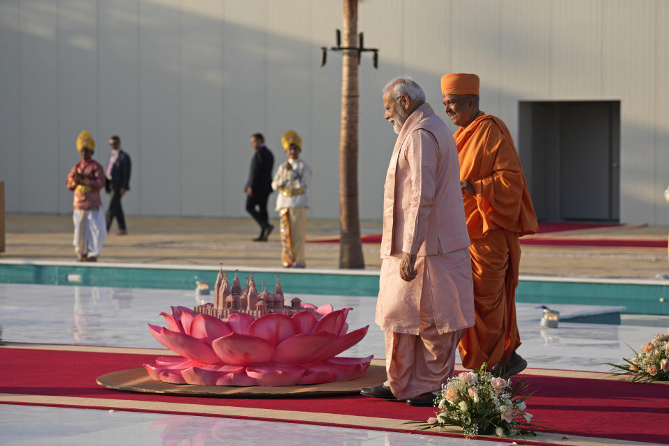 Indian Prime Minister Narendra Modi, front left, looks at a miniature model of the first stone-built Hindu temple in the Middle East, belonging to Bochasanwasi Akshar Purushottam Swaminarayan Sanstha, after arriving for the temple's opening ceremony in Abu Mureikha, 40 kilometers (25 miles) northeast of Abu Dhabi, United Arab Emirates, Wednesday, Feb. 14, 2024. (AP Photo/Kamran Jebreili)