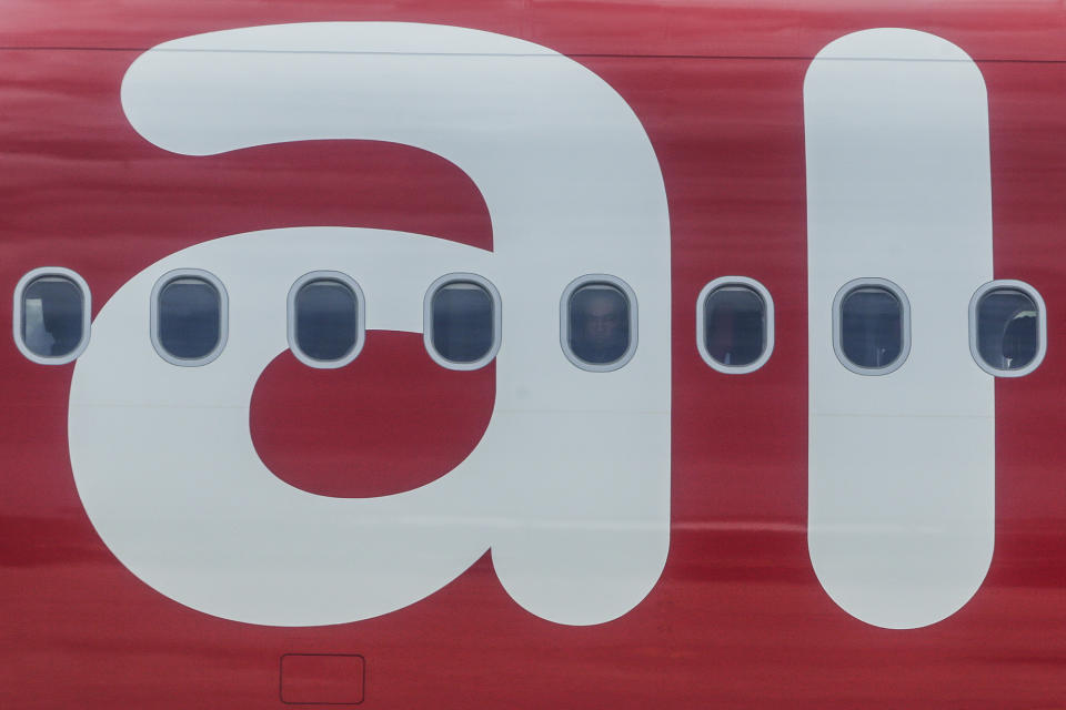 <p>A Syrian migrant (C) looks out from a window of an AirAsia airplane as they arrive at the Royal Malaysian Air Force (RMAF) airbase in Subang, outside Kuala Lumpur, Malaysia, May 28, 2016. The second batch of 68 Syria migrants arrived in Malaysia under the Humanitarian Program for Syrian Migrants, for internal displaced persons from a Bekaa Valley Camp in Lebanon. (EPA/FAZRY ISMAIL) </p>