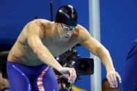 2016 Rio Olympics - Swimming - Men's 4 x 200m Freestyle Relay - Olympics Aquatics Stadium - Rio de Janeiro, Brazil - 09/08/2016. Michael Phelps (USA) of USA prepares to swim with an inverted Speedo cap borrowed from teammate Conor Dwyer after his own "MP" cap ripped. Picture taken August 9, 2016. REUTERS/Michael Dalder