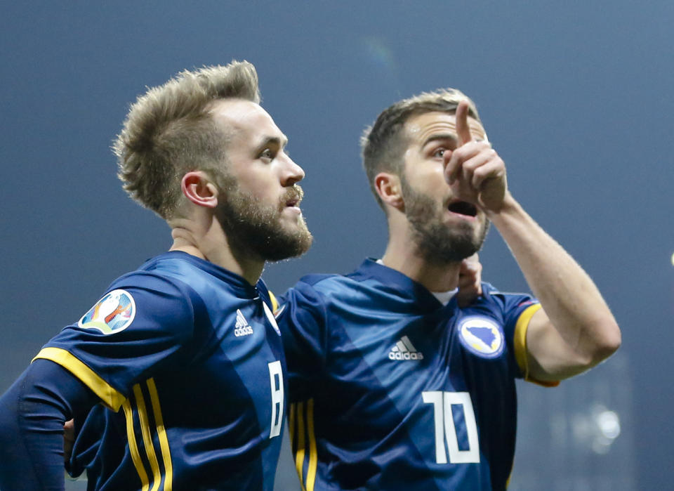 Bosnia's Edin Visca, left, celebrates after scoring his side's first goal together with Bosnia's Miralem Pjanic during the Euro 2020 group J qualifying soccer match between Bosnia-Herzegovina and Greece in Zenica, Bosnia, Tuesday, March 26, 2019. (AP Photo/Darko Bandic)