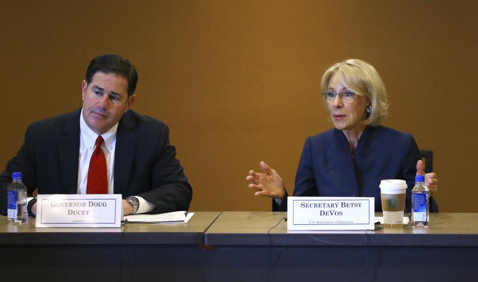 U.S. Education Secretary Betsy DeVos, right, joins Arizona Republican Gov. Doug Ducey, as they answer questions during a roundtable discussion on school choice Thursday, Dec. 5, 2019, in Scottsdale, Ariz. DeVos talks with state lawmakers, educators, students and parents about her $5 billion plan to fund tuition for private school students, prior to addressing the American Legislative Exchange Council. (AP Photo/Ross D. Franklin)