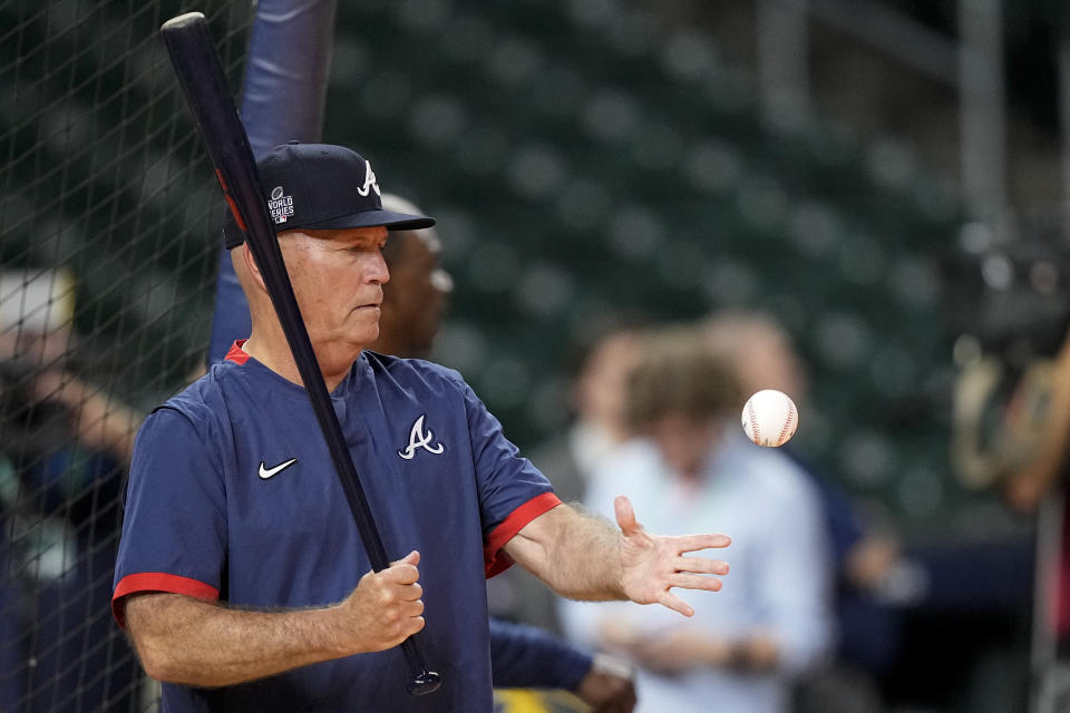 Atlanta Braves manager Brian Snitker hits batting practice Monday, Oct. 25, 2021, in Houston, in preparation for Game 1 of baseball's World Series tomorrow against the Houston Astros. (AP Photo/David J. Phillip)