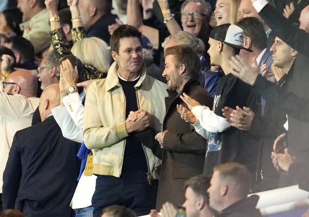 Tom Brady and David Beckham share a handshake during the match in Birmingham.