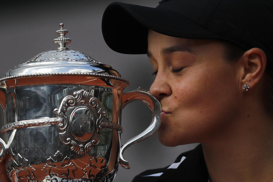 Australia's Ashleigh Barty kisses the trophy as she celebrates winning her women's final match of the French Open tennis tournament against Marketa Vondrousova of the Czech Republic in two sets 6-1, 6-3, at the Roland Garros stadium in Paris, Saturday, June 8, 2019. (AP Photo/Michel Euler)