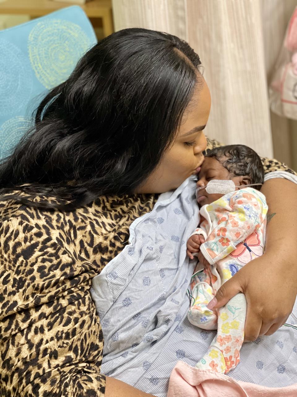 Brittany Moultrie holds her baby girl, Charli, who benefited from donated milk.