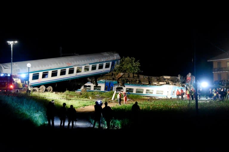 Firefighters and rescue personnel work at the site of a train crash in Caluso, outside Turin on May 24, 2018