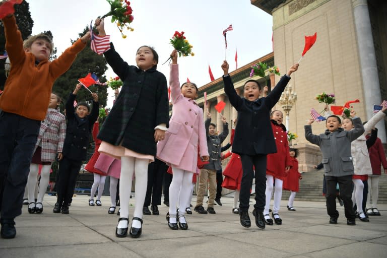 Children waved national flags before the arrival of the two leaders