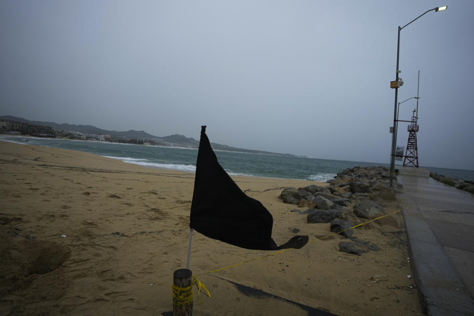 A black flag waves in the wind, signaling a closed beach, prior the arrival of the hurricane Norma in Cabo San Lucas, Mexico, Friday, Oct. 20, 2023. Hurricane Norma is heading for the resorts of Los Cabos at the southern tip of Mexico's Baja California Peninsula, while Tammy grew into a hurricane in the Atlantic. (AP Photo/Fernando Llano)