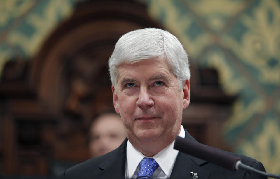 FILE - In this Tuesday, Jan. 23, 2018, file photo, Michigan Gov. Rick Snyder delivers his State of the State address to a joint session of the House and Senate at the state Capitol in Lansing, Mich. Authorities investigating Flint's water crisis have seized from storage the state-owned mobile devices of Snyder and 65 other current or former officials. Documents obtained through a public records request show search warrants were sought two weeks ago by the attorney general's office and signed by a Flint judge. (AP Photo/Al Goldis, File)