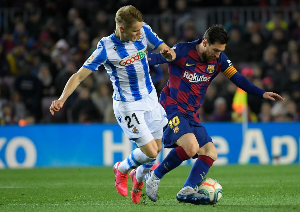 Real Sociedad's Norwegian midfielder Martin Odegaard (L) challenges Barcelona's Argentine forward Lionel Messi during the Spanish league football match between FC Barcelona and Real Sociedad at the Camp Nou stadium in Barcelona on March 7, 2020. (Photo by LLUIS GENE / AFP) (Photo by LLUIS GENE/AFP via Getty Images)