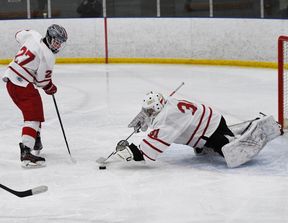 Canandaigua goalie Charlie Fuller makes the save with teammate Brody Spinosa there to help.