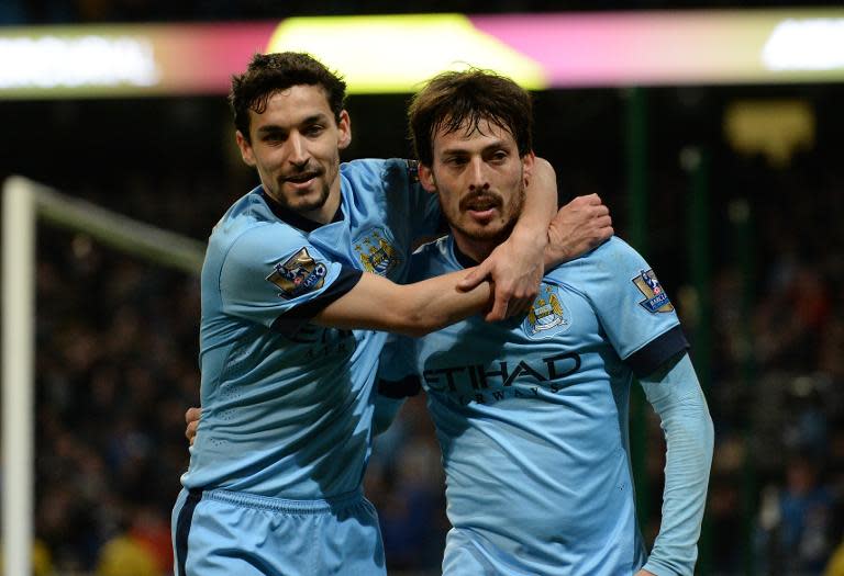 Manchester City's David Silva (R) celebrates scoring a goal with teammate Jesus Navas during their English Premier League match against Leicester City, at the Etihad Stadium in Manchester, north-west England, on March 4, 2015