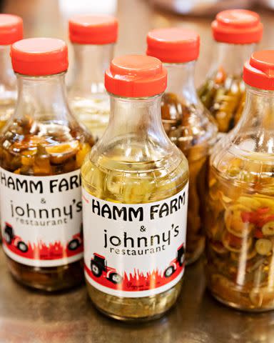 Robbie Caponetto Johnny’s Restaurant in Homewood, Alabama is stocked with bottles of pepper sauce sourced from a nearby farm.