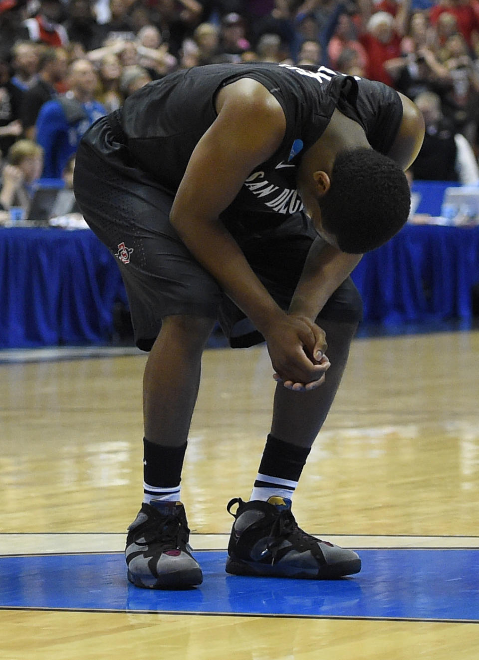 San Diego State forward Dwayne Polee II (5) hangs his head after time expired during a regional semifinal NCAA college basketball tournament game against Arizona, Thursday, March 27, 2014, in Anaheim, Calif. Arizona win 70-64. (AP Photo/Mark J. Terrill)