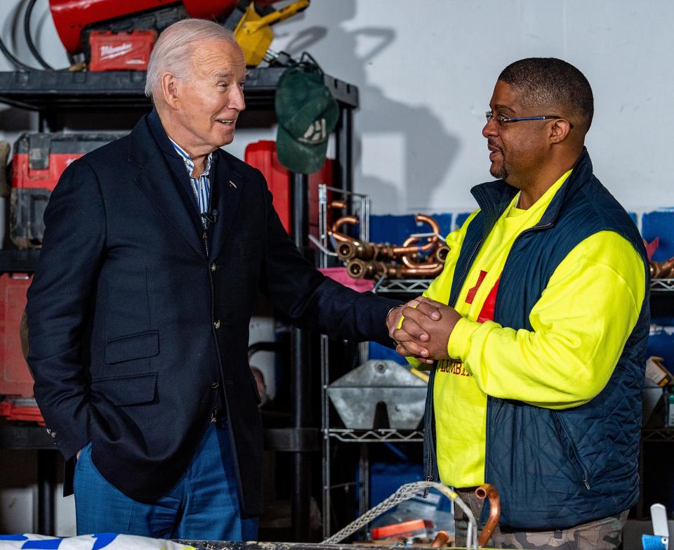 President Joe Biden speaks with Rashawn Spivey at Hero Plumbing before heading to speak at the Wisconsin Black Chamber Commerce on Wednesday in Milwaukee