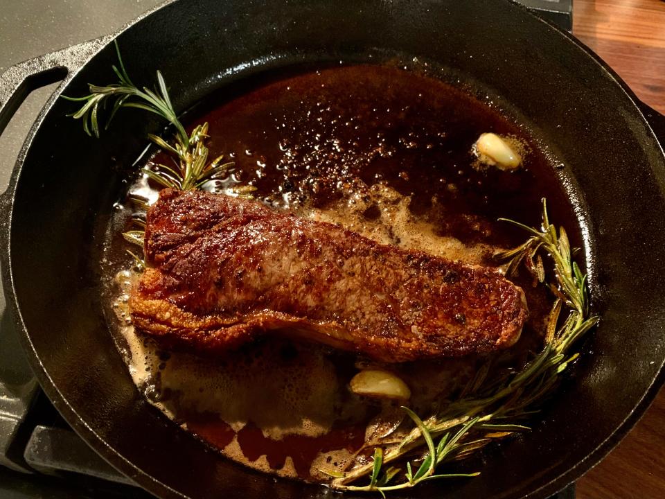 steak in oil on pan