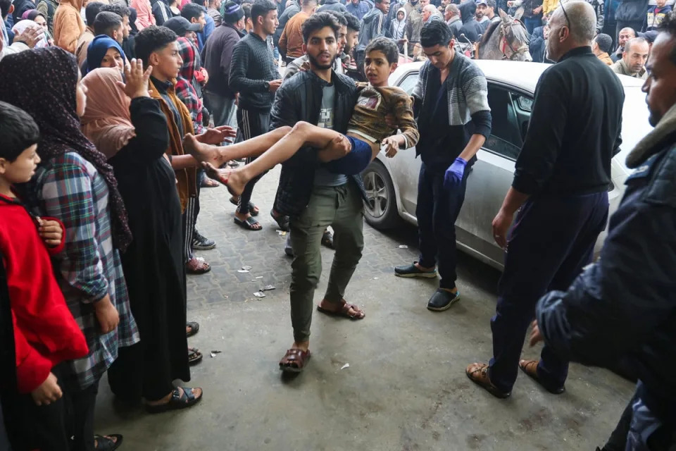 A child is taken into hospital in Khan Younis (Reuters)