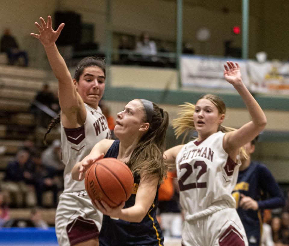 Kayla Johannesen of Our Lady of Lourdes splits Walt Whitman defenders during a New York State girls Class AAA basketball semifinal against at Hudson Valley Community College in Troy March 16, 2024. Lourdes defeated Walt Whitman 60-51 to advance to the Class AAA final on Sunday.