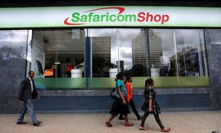 Pedestrians walk past a mobile phone care centre operated by Kenyan's telecom operator Safaricom in the central business district of Kenya's capital Nairobi, May 11, 2016. REUTERS/Thomas Mukoya