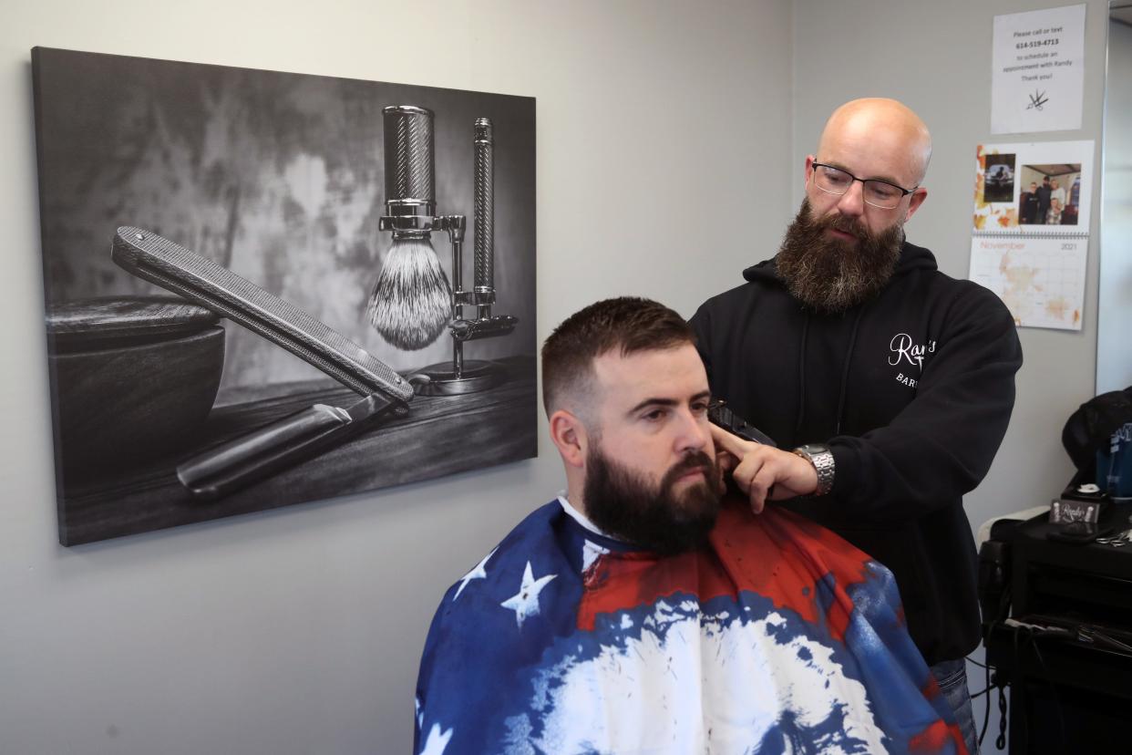 Owner and barber Randy Ash trims Canal Winchester resident Matt Fryer's hair Nov. 9 at Randy's Barbershop in Pickerington.