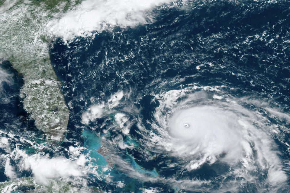 This GOES-16 satellite image taken Saturday, Aug. 31, 2019, at 16:00 UTC and provided by National Oceanic and Atmospheric Administration (NOAA), shows Hurricane Dorian, right, churning over the Atlantic Ocean. Hurricane Dorian bore down on the Bahamas as a fierce Category 4 storm Saturday, with new projections showing it curving upward enough to potentially spare Florida a direct hit but still threatening parts of the Southeast U.S. with powerful winds and rising ocean water that causes what can be deadly flooding.(NOAA via AP)