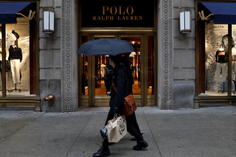 People walk past Ralph Lauren Corp.'s flagship Polo store on Fifth Avenue in New York