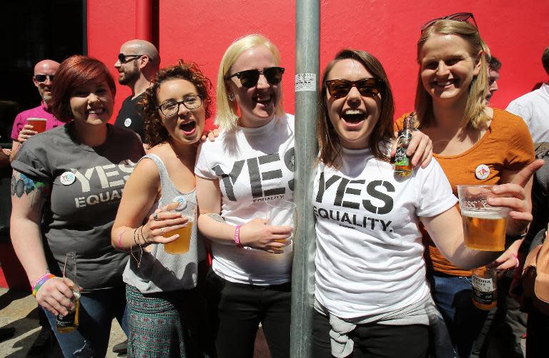 Supporters of same-sex marriage celebrate outside a gay bar in Dublin on May 23, 2015