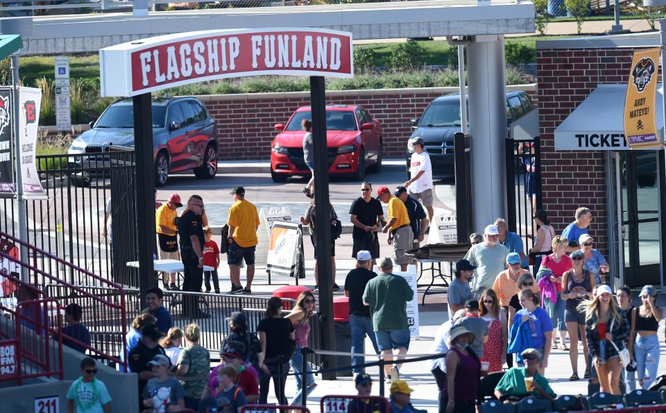 Ticket takers in yellow shirts and red hats welcome fans to UPMC Park to watch the Erie SeaWolves play the Richmond Flying Squirrels on Sept. 18, 2021.