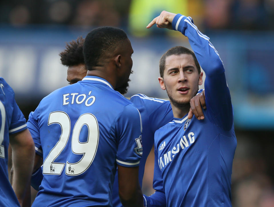 Chelsea's Eden Hazard, right, celebrates after scoring the opening goal and points towards teammate Samuel Eto'o who provided the assist during their English Premier League soccer match between Chelsea and Newcastle United in London Saturday, Feb 8 2014. (AP Photo/Alastair Grant)