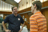 Kentucky Gov. Andy Beshear, left, speaks with Derrek McIntosh about the arrival of travel trailers to be used as temporary housing at Jenny Wiley State Park in Prestonsburg, Ky., Tuesday, Sept. 6, 2022. Despite being a Democratic governor in a Republican dominated state, Beshear has a large amount of support from Kentucky residents. (AP Photo/Timothy D. Easley)