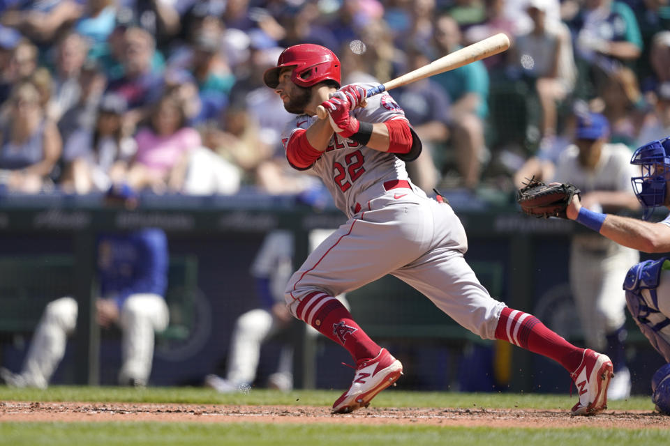 Los Angeles Angels' David Fletcher hits an RBI single in the seventh inning of a baseball game against the Seattle Mariners, Sunday, July 11, 2021, in Seattle. (AP Photo/Ted S. Warren)