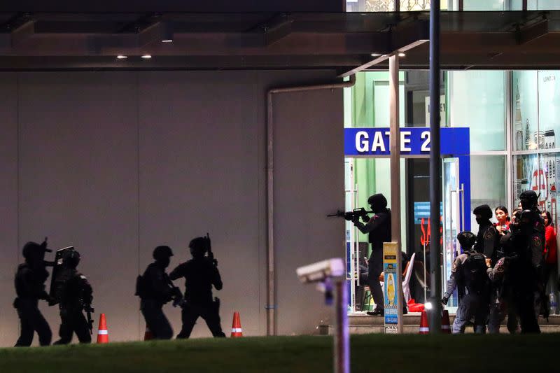 Thailand security forces enter in a shopping mall as they chase a shooter hidden in after a mass shooting in front of the Terminal 21, in Nakhon Ratchasima
