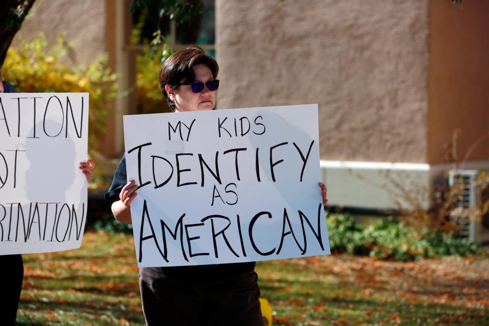 People protest outside the offices of the New Mexico Public Education Department's office last November after the state education department proposed changes to the social studies curriculum that critics describe as a veiled attempt to teach critical race theory. Supporters say the new curriculum, which includes ethnic studies, is "anti-racist." (AP Photo/Cedar Attanasio, File)