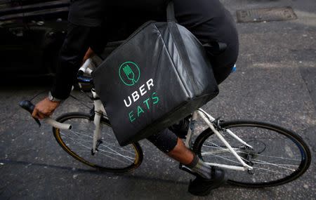 An UberEATS food delivery courier rides his bike in London, Britain September 7, 2016. REUTERS/Neil Hall