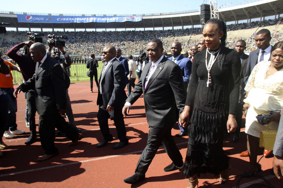 Zimbabwean Deputy President Constantino Chiwenga is seen with his wife Mary upon arrival for the inauguration ceremony of President Emmerson Mnangagwa, at the National Sports Stadium in Harare, Sunday, Aug. 26, 2018. Zimbabweans have begun arriving at a national stadium for the inauguration of President Emmerson Mnangagwa after a bitterly disputed election.(AP Photo/Wonder Mashura)