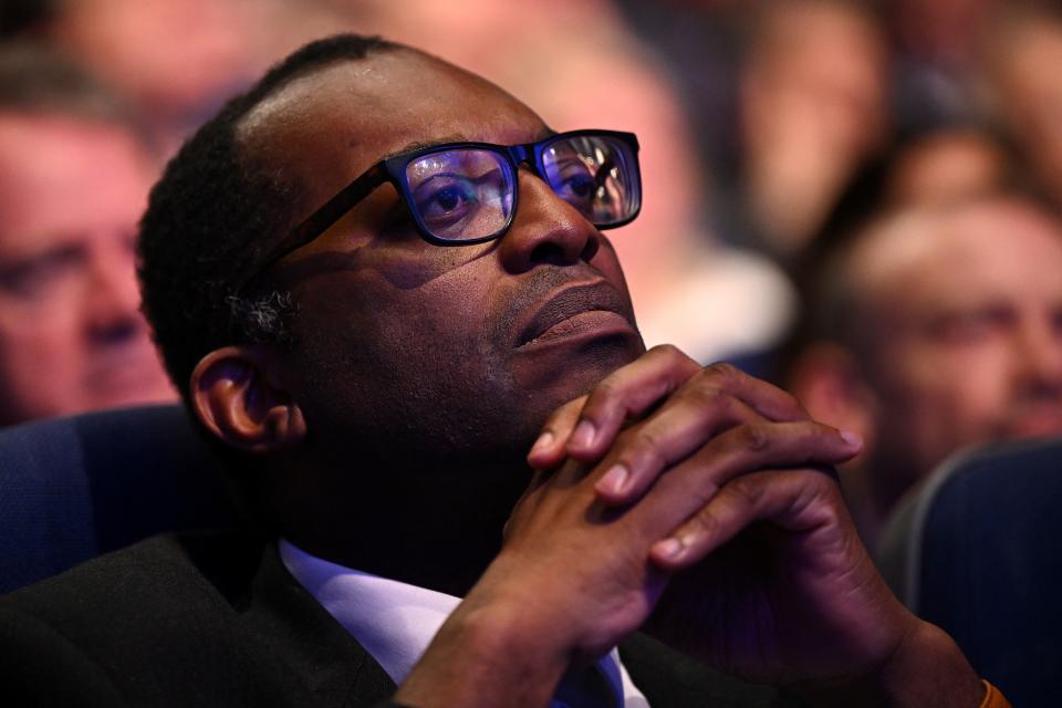 Britain's Chancellor of the Exchequer Kwasi Kwarteng listens as Britain's Prime Minister Liz Truss (unseen) delivers her keynote address on the final day of the annual Conservative Party Conference in Birmingham, central England, on October 5, 2022. (Photo by Oli SCARFF / AFP) (Photo by OLI SCARFF/AFP via Getty Images)