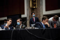 Sen. Joshua Hawley, R-Mo., left, and Sen. Ben Sasse, R-Neb., speak with aides during a Senate Judiciary Committee business meeting to consider authorization for subpoenas relating to the Crossfire Hurricane investigation, and other matters on Capitol Hill in Washington, Thursday, June 11, 2020. (Erin Schaff/The New York Times via AP, Pool)