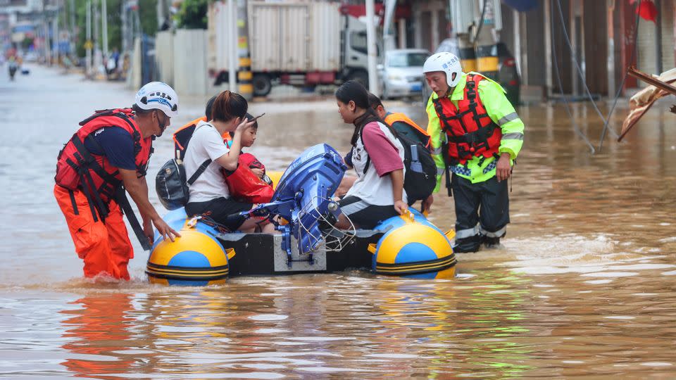 A civilian rescue team help flood-stranded people onto a rubber boat in Quanzhou in  southeast China's Fujian province on July 29, 2023.  - Xinhua News Agency/Getty Images